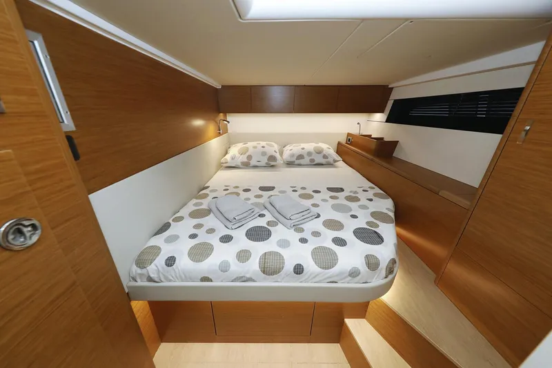 Volare Yacht Photos Pics Luxurious cabin interior of 2025 Hanse 590 yacht with cozy bed and modern design.