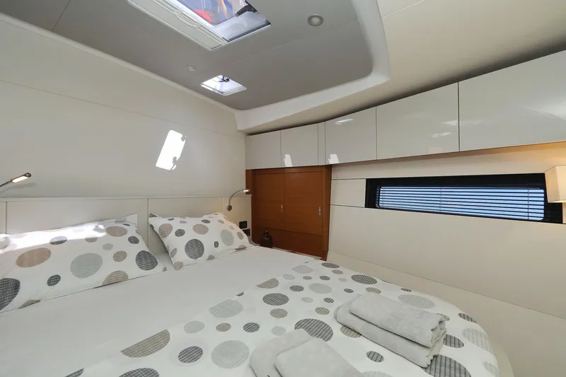 Volare Yacht Photos Pics Luxurious cabin interior of 2025 Hanse 590 yacht with modern design and cozy bedding.