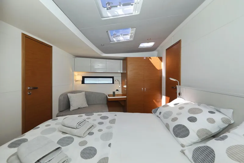 Volare Yacht Photos Pics Luxurious cabin interior of 2025 Hanse 590 yacht with modern decor and skylights.