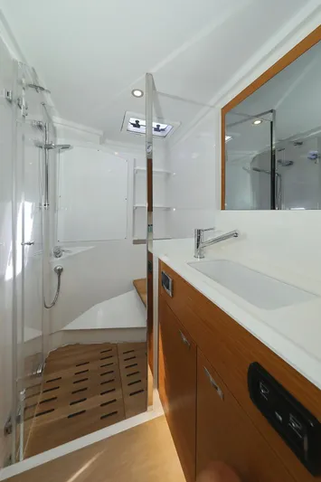 Volare Yacht Photos Pics Luxurious bathroom in 2025 Hanse 590 yacht with modern fixtures and wooden accents.