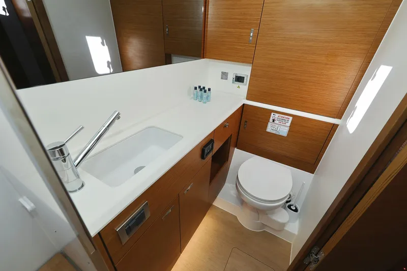 Volare Yacht Photos Pics Modern bathroom in 2025 Hanse 590 yacht with sleek fixtures and wooden cabinetry.