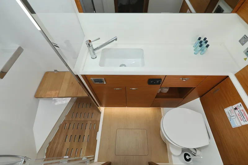 Volare Yacht Photos Pics Modern bathroom interior of 2025 Hanse 590 yacht with wooden cabinetry and sleek fixtures.