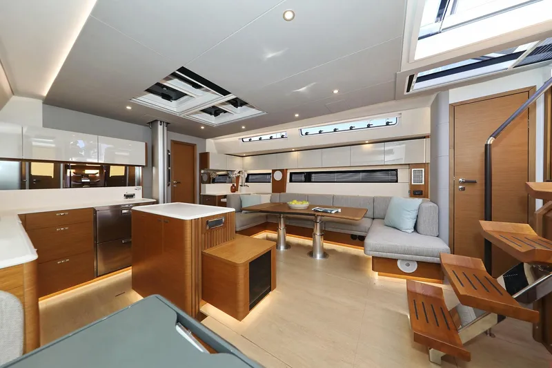Volare Yacht Photos Pics Luxurious interior of 2025 Hanse 590 yacht with modern kitchen and seating area.