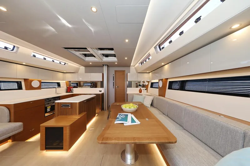 Volare Yacht Photos Pics Luxurious interior of 2025 Hanse 590 yacht with modern kitchen and seating area.