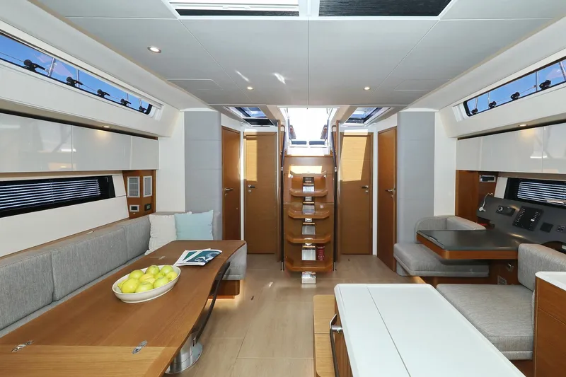 Volare Yacht Photos Pics Luxurious interior of 2025 Hanse 590 yacht with modern seating and dining area.