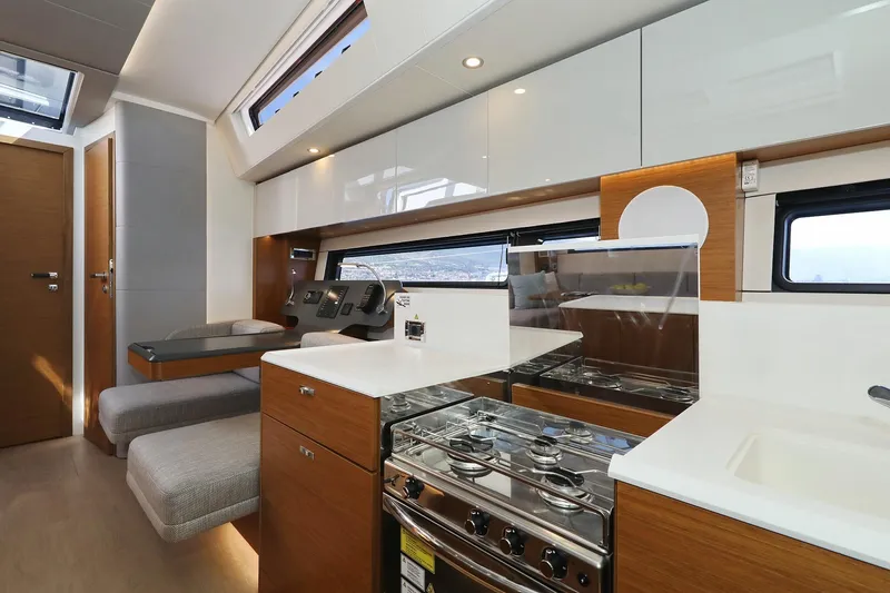 Volare Yacht Photos Pics Modern kitchen interior of 2025 Hanse 590 yacht with sleek cabinetry and appliances.
