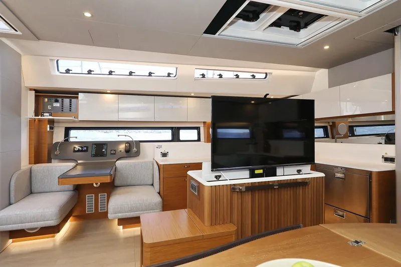 Volare Yacht Photos Pics Luxurious interior of 2025 Hanse 590 yacht with modern furnishings and large TV.