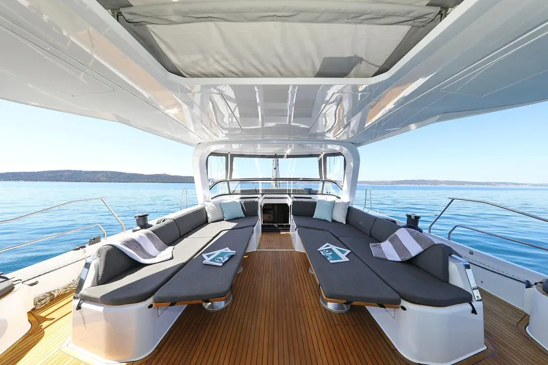 Volare Yacht Photos Pics Luxurious 2025 Hanse 590 yacht deck with comfortable seating and ocean view.