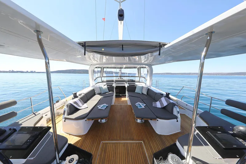 Volare Yacht Photos Pics Luxurious 2025 Hanse 590 yacht deck with elegant seating and ocean view.