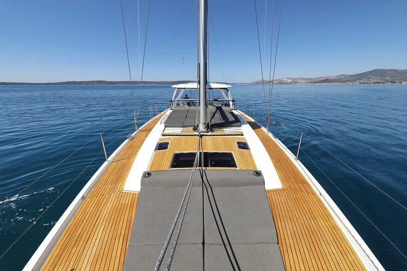 Volare Yacht Photos Pics 2025 Hanse 590 yacht on calm sea, showcasing sleek deck design and clear blue skies.