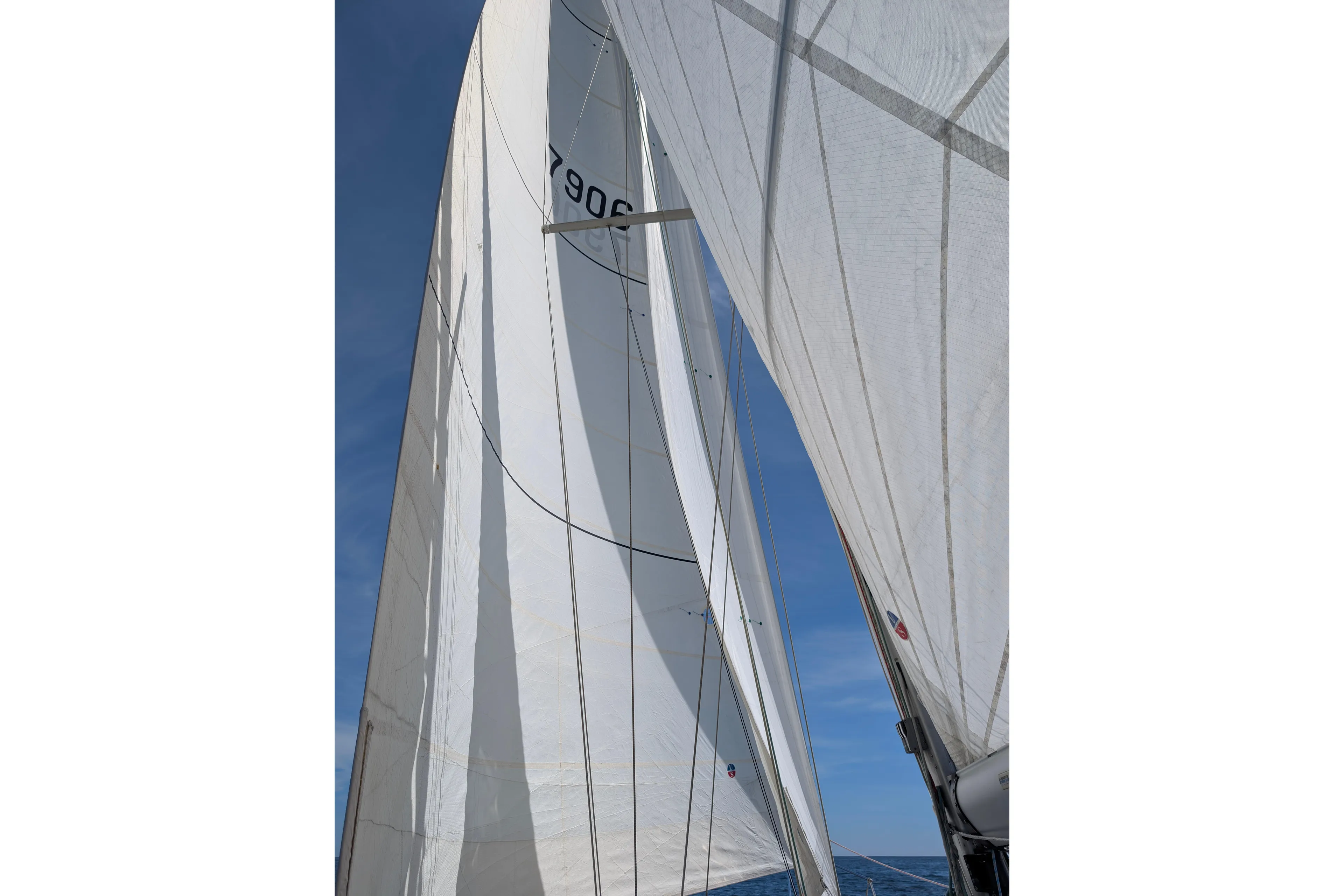 Skoal Yacht Photos Pics Sails of a 2004 Cabo Rico 42 yacht against a clear blue sky.
