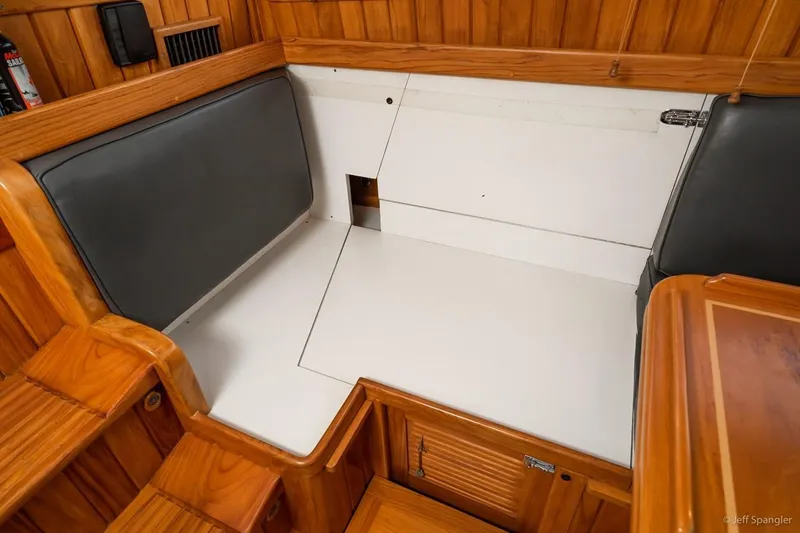 Skoal Yacht Photos Pics Interior of 2005 Cabo Rico 42 Pilot yacht with wooden finish and seating area.
