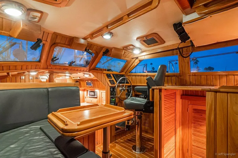 Skoal Yacht Photos Pics Luxurious 2005 Cabo Rico 42 Pilot yacht interior with wooden finish and steering wheel.