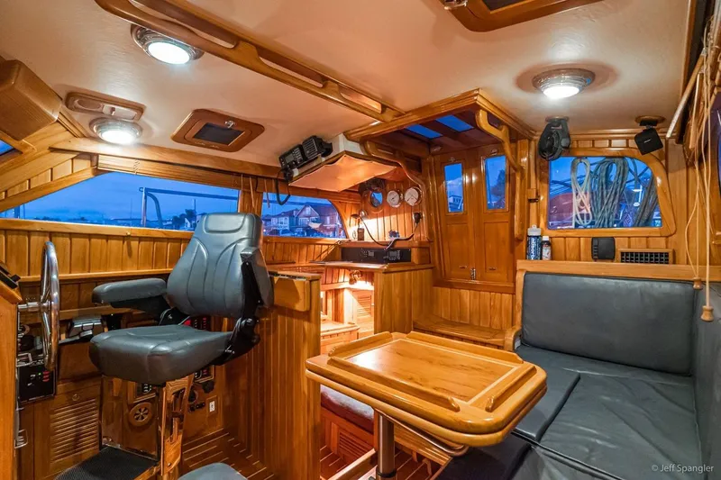 Skoal Yacht Photos Pics Luxurious 2005 Cabo Rico 42 Pilot yacht interior with wooden finish and modern navigation equipment.