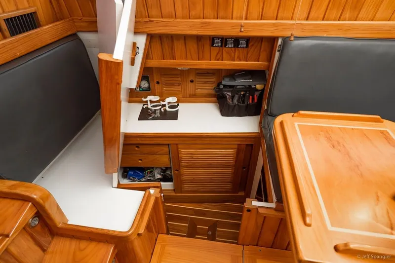 Skoal Yacht Photos Pics Interior of 2005 Cabo Rico 42 Pilot, featuring wooden cabinetry and seating area.
