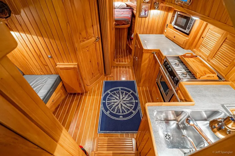 Skoal Yacht Photos Pics Luxurious 2005 Cabo Rico 42 Pilot yacht interior with wood paneling and modern kitchen amenities.