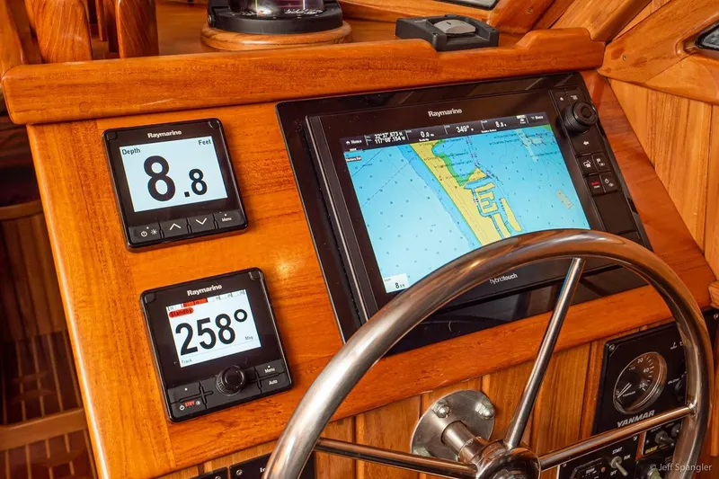 Skoal Yacht Photos Pics Helm of 2005 Cabo Rico 42 Pilot with Raymarine navigation displays and steering wheel.