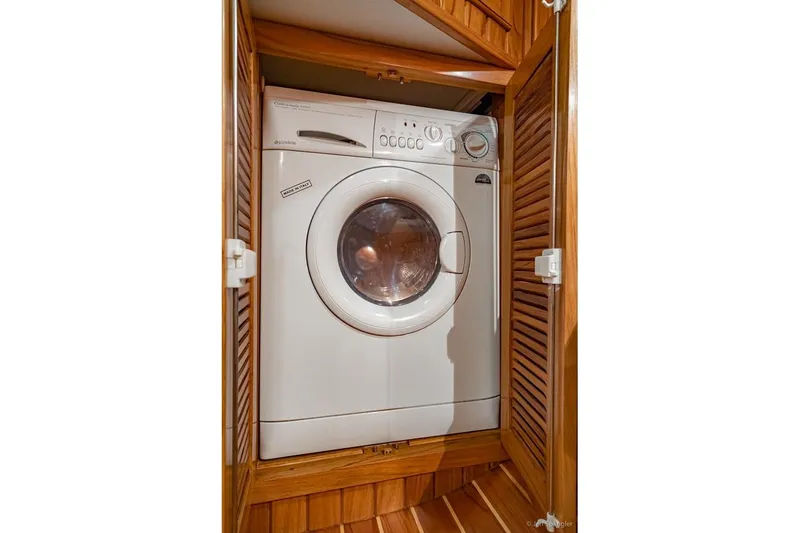 Skoal Yacht Photos Pics Washing machine in wooden cabinet aboard 2005 Cabo Rico 42 Pilot yacht.