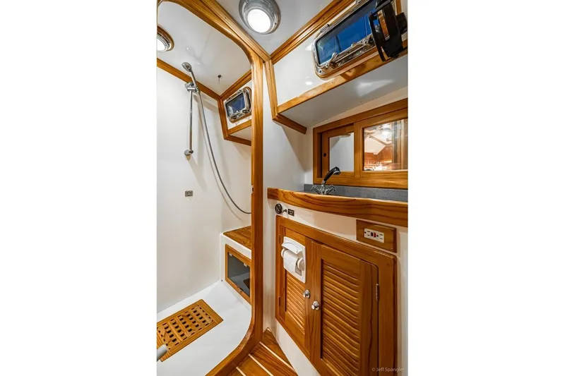 Skoal Yacht Photos Pics Luxurious 2005 Cabo Rico 42 Pilot yacht bathroom with wooden accents and modern fixtures.