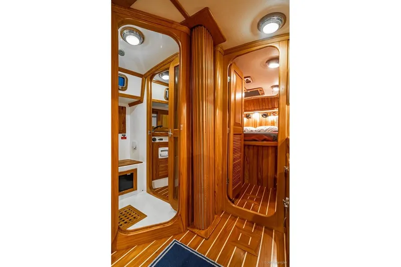 Skoal Yacht Photos Pics Luxurious 2005 Cabo Rico 42 Pilot yacht interior with wood finish and cozy cabin.