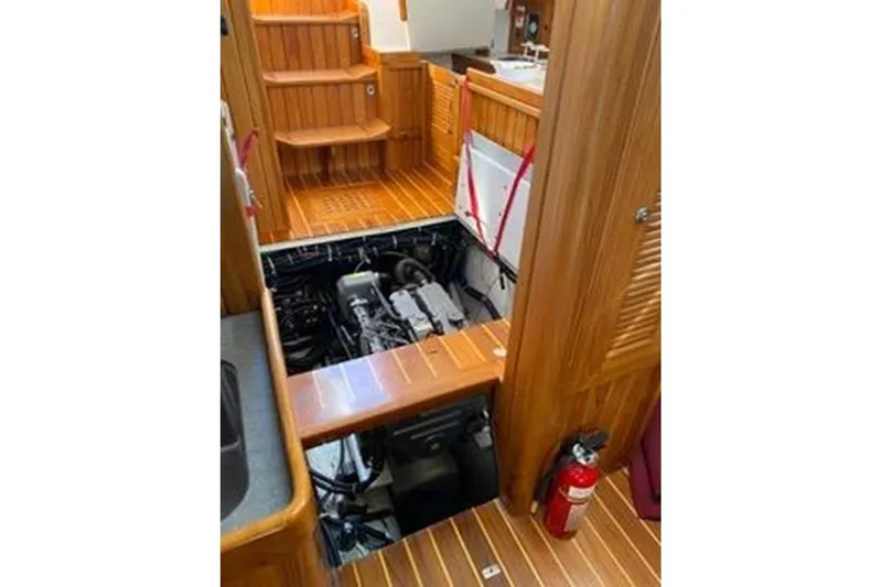 Skoal Yacht Photos Pics 2005 Cabo Rico 42 Pilot yacht interior with open engine compartment and wooden flooring.