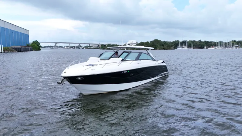  Yacht Photos Pics 2015 Cobalt A40 boat cruising on a calm river under cloudy skies.