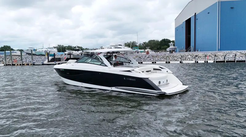  Yacht Photos Pics 2015 Cobalt A40 boat on water near a blue building.