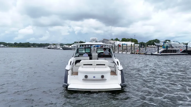  Yacht Photos Pics 2015 Cobalt A40 boat on water near marina under cloudy sky.