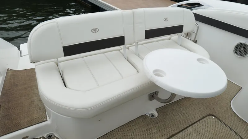  Yacht Photos Pics Luxury seating area on 2015 Cobalt A40 boat with white cushions and round table.