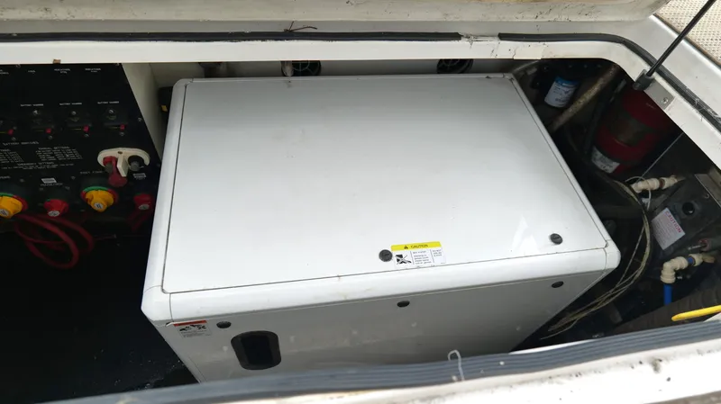  Yacht Photos Pics Engine compartment of a 2015 Cobalt A40 boat, featuring a white generator unit.