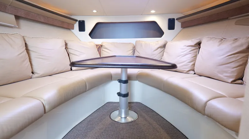  Yacht Photos Pics Luxurious interior of 2015 Cobalt A40 boat with beige seating and central table.