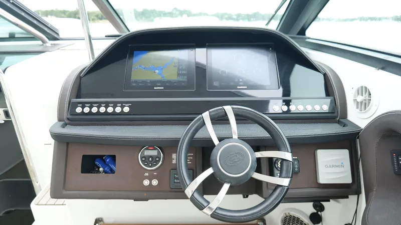 Yacht Photos Pics 2015 Cobalt A40 boat dashboard with steering wheel and navigation screens.