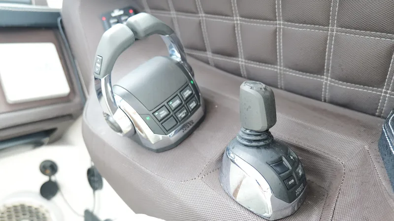  Yacht Photos Pics Control panel of a 2015 Cobalt A40 boat with joystick and buttons.