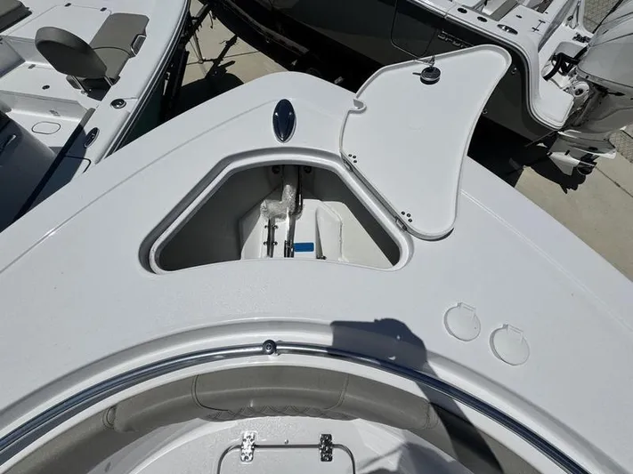  Yacht Photos Pics 2025 Sportsman Heritage 261 boat with open storage compartment on deck.