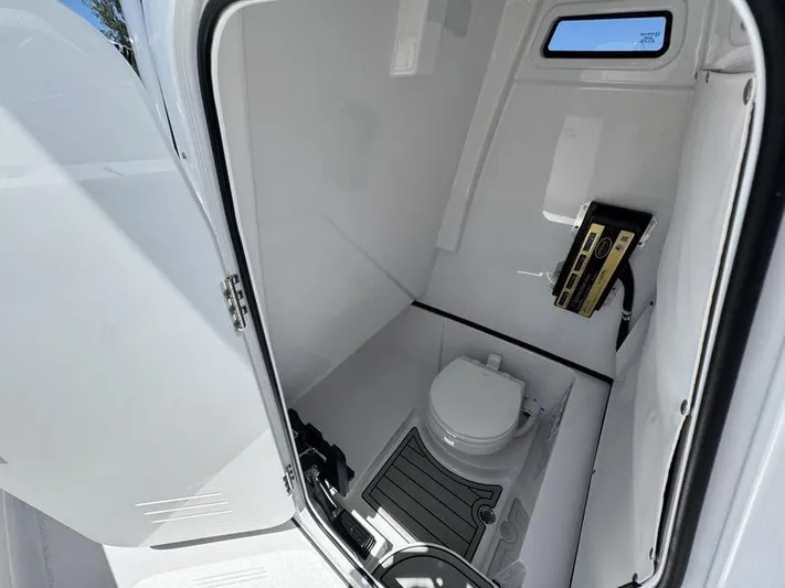  Yacht Photos Pics 2025 Sportsman Heritage 261 boat interior with compact marine toilet and storage.