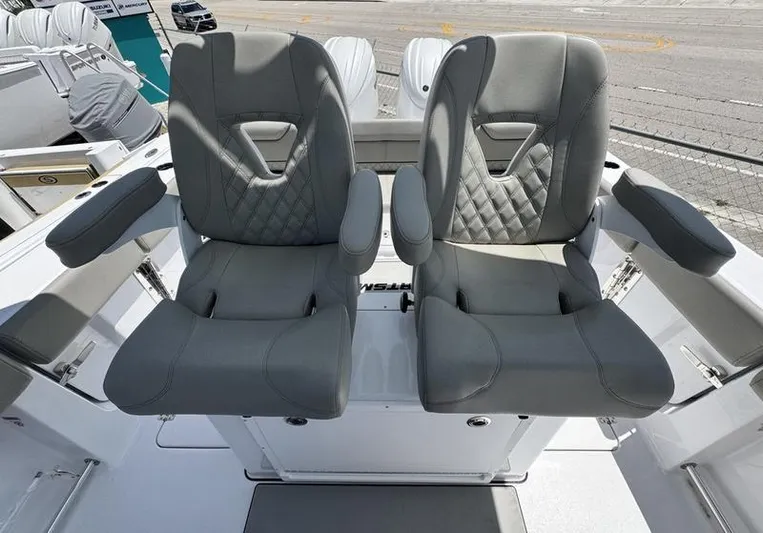  Yacht Photos Pics Two luxurious gray seats on a 2025 Sportsman Heritage 261 boat.