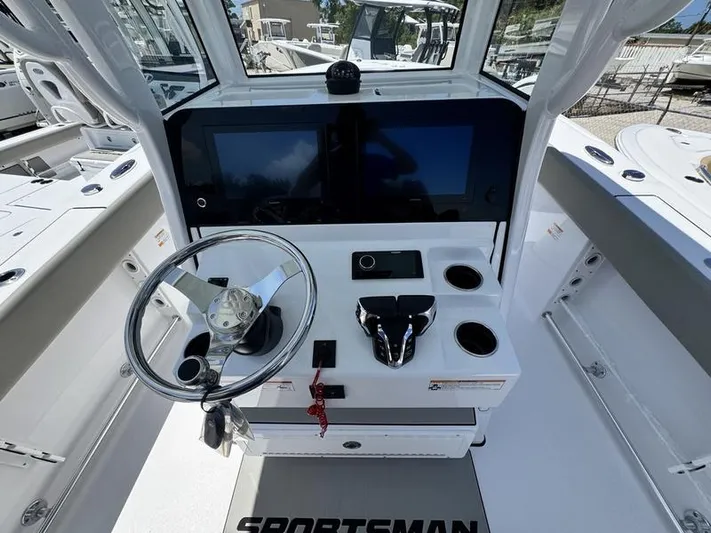  Yacht Photos Pics 2025 Sportsman Heritage 261 boat dashboard with steering wheel and dual screens.