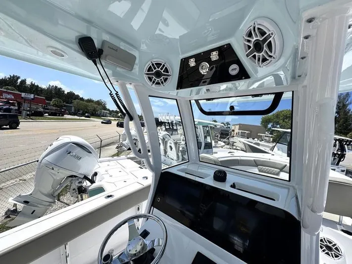  Yacht Photos Pics Interior view of 2025 Sportsman Heritage 261 boat, showcasing helm and controls.