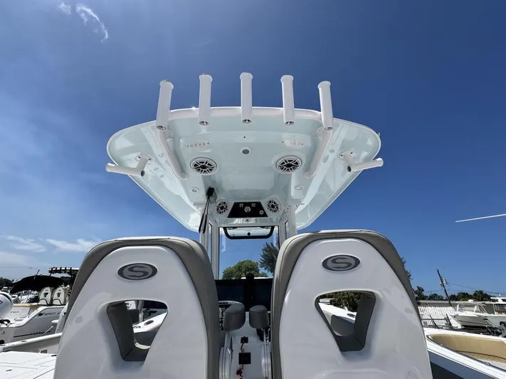  Yacht Photos Pics 2025 Sportsman Heritage 261 boat with dual seats and overhead console against clear blue sky.