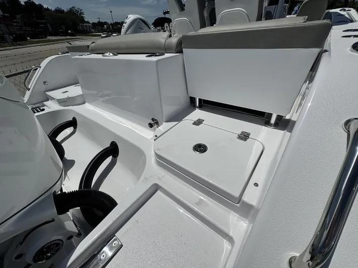  Yacht Photos Pics 2025 Sportsman Heritage 261 boat interior with seating and storage compartments.