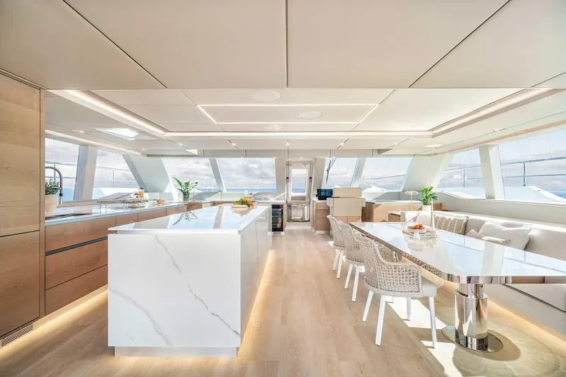  Yacht Photos Pics Luxurious interior of 2026 Sunreef 70 Sunreef Power yacht with modern dining area and panoramic windows.