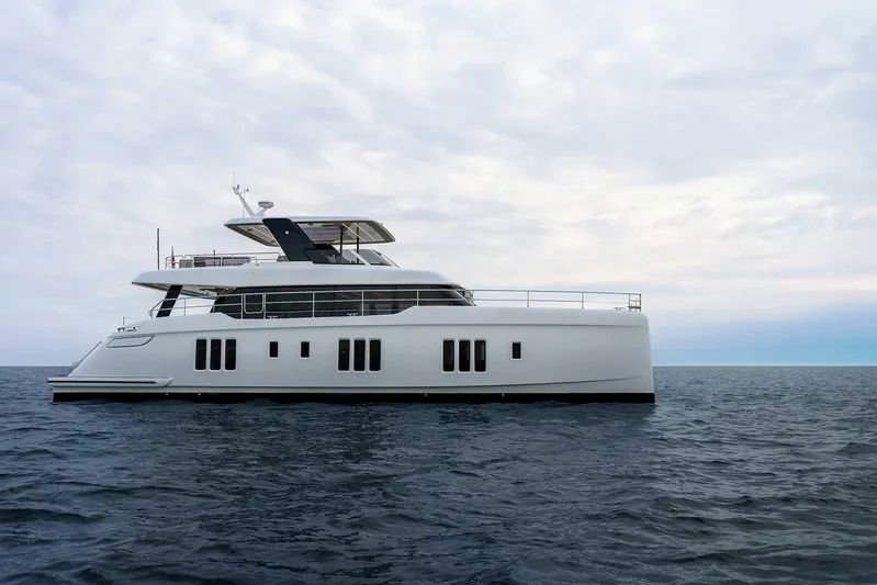  Yacht Photos Pics 2026 Sunreef 70 Sunreef Power yacht on open sea under cloudy sky.