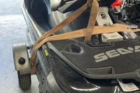 2014 Sea-Doo 260 RXT jet ski secured on a trailer in a garage.