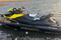 2014 Sea-Doo 260 RXT jet ski docked by a marina at sunset.