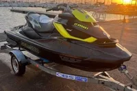 2014 Sea-Doo 260 RXT jet ski on trailer at sunset by marina.