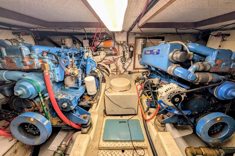 Positive Space Yacht Photos Pics Engine room of a 1987 DeFever Trawler with dual blue marine engines.