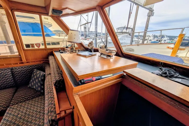 Positive Space Yacht Photos Pics 1987 DeFever Trawler interior with wooden furnishings and marina view.
