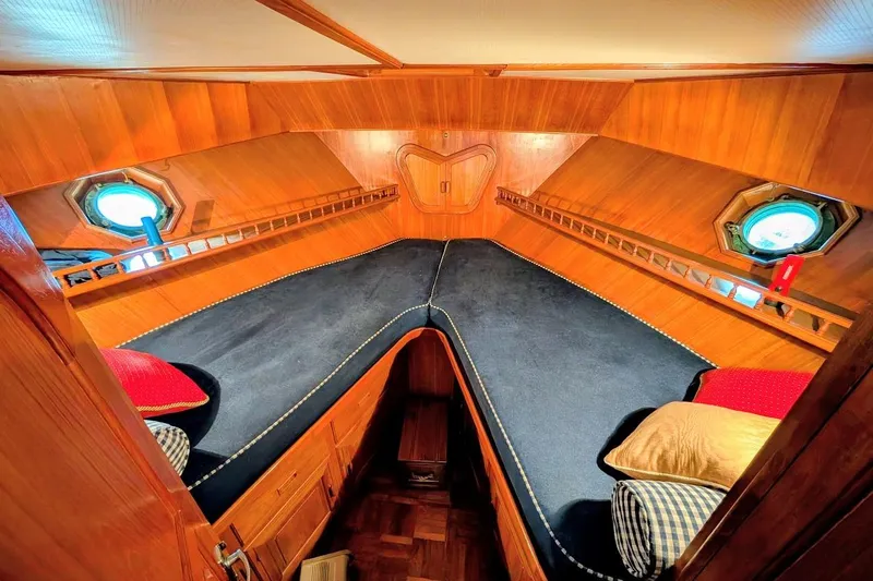 Positive Space Yacht Photos Pics Cozy 1987 DeFever Trawler cabin with wooden interior and porthole windows.