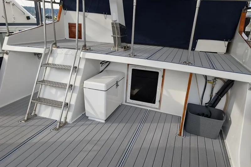 Positive Space Yacht Photos Pics 1987 DeFever Trawler deck with ladder, storage box, and marine equipment.