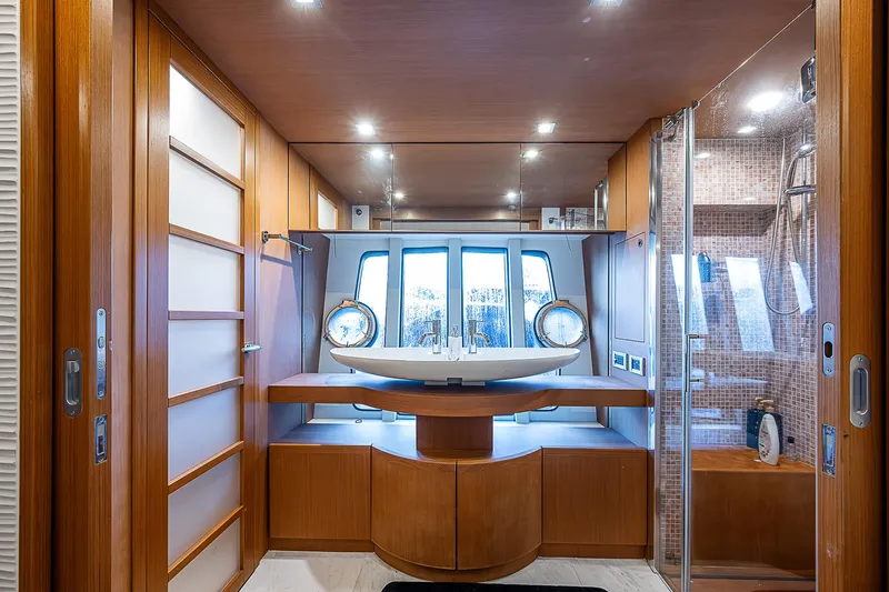 Twe11ve Yacht Photos Pics Luxurious bathroom on 2009 Ferretti Yachts 780 MY with modern fixtures and wood accents.
